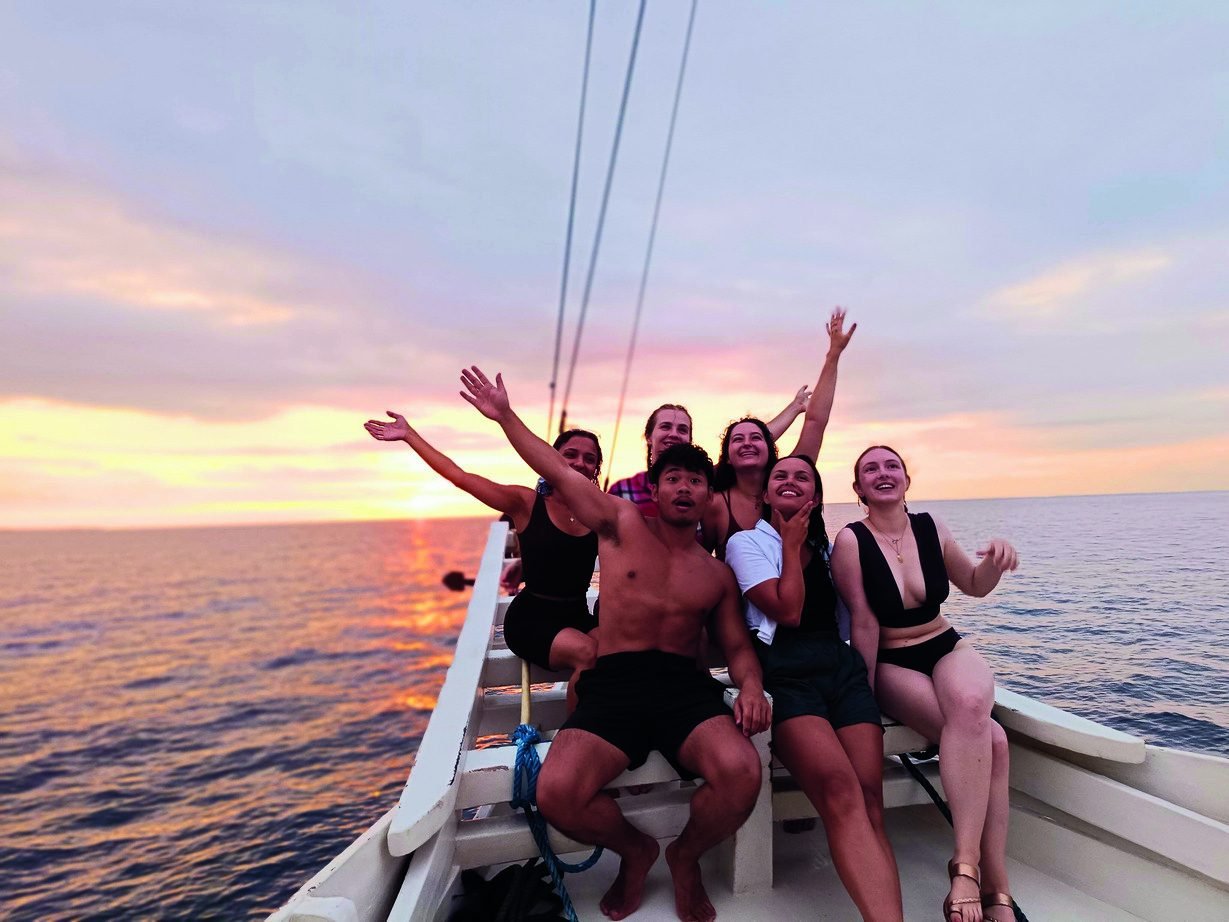Guests enjoying sunset on the boat deck
