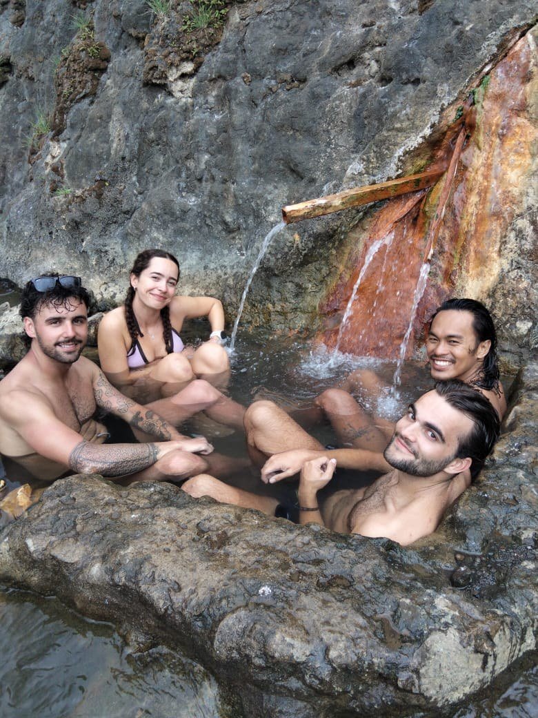 Trekkers relaxing at the natural hot spring